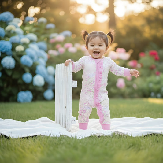 EVERLY’S FLOWERS RUFFLE BUTT FOOTIE SLEEPER