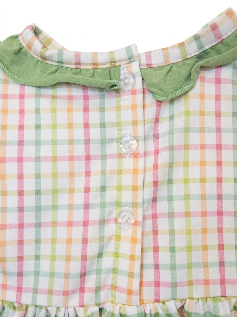 Close-up view of three clear buttons and green ruffled collar on the back of baby plaid romper.
