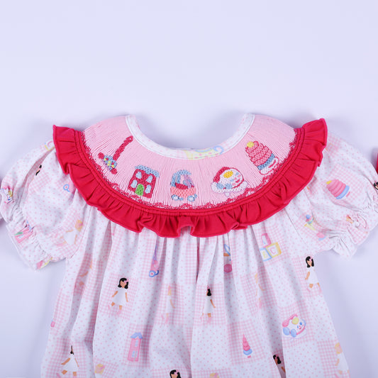 Close-up of the embroidered vintage toy collar on the Dolly & Me pink hand-smocked bubble romper for babies.