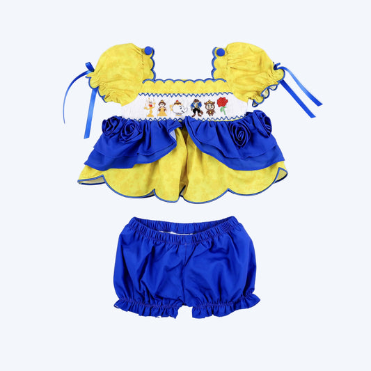 Girls yellow and blue smocked bloomer set featuring hand-embroidered fairytale character top and matching shorts.