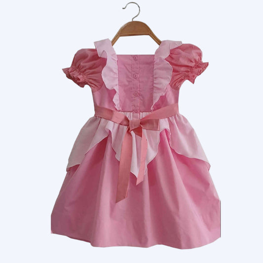 Back view of a girls pink princess dress on a hanger, featuring a button-down back, ruffles, and a waist bow.