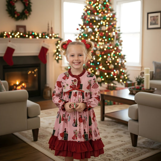 Young girl wearing a vintage 50s Christmas ladies pink nightgown with red ruffles by a festive Christmas tree.