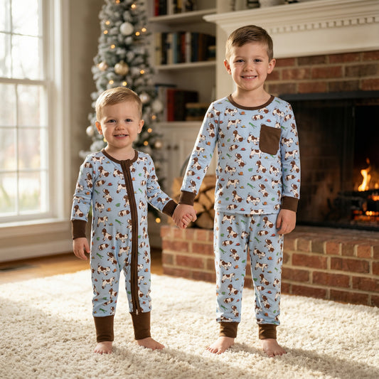Brothers holding hands wearing matching Snips and Snails blue puppy dog pajamas.