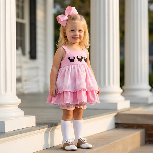 Toddler girl wearing a Pink Bow Mouse French Knot Bloomer Set featuring tiered gingham ruffles and embroidered mouse details.