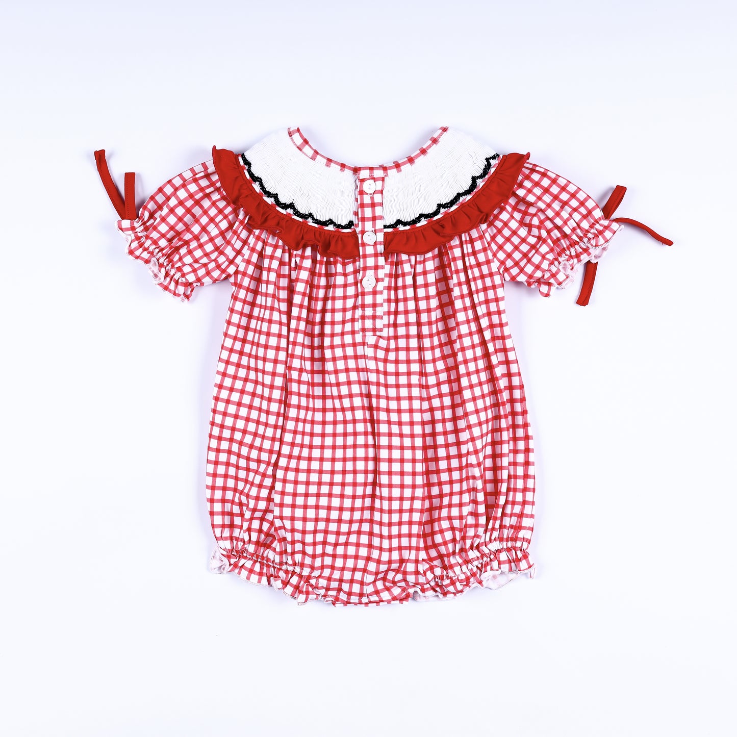 Full back view of red gingham hand-smocked bubble romper showing back button closure placket and ruffled collar.