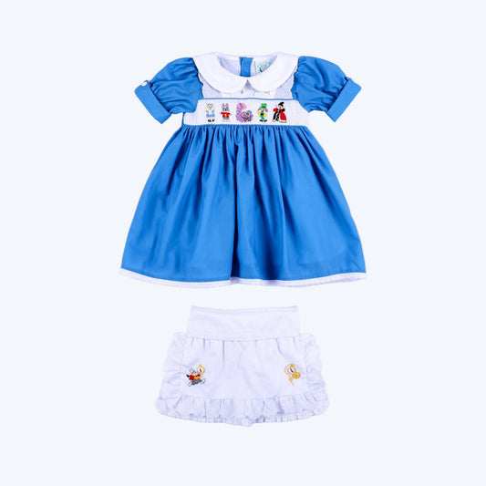 Storybook Wonderland blue hand smocked dress and white eyelet apron set for toddler girls full front view.