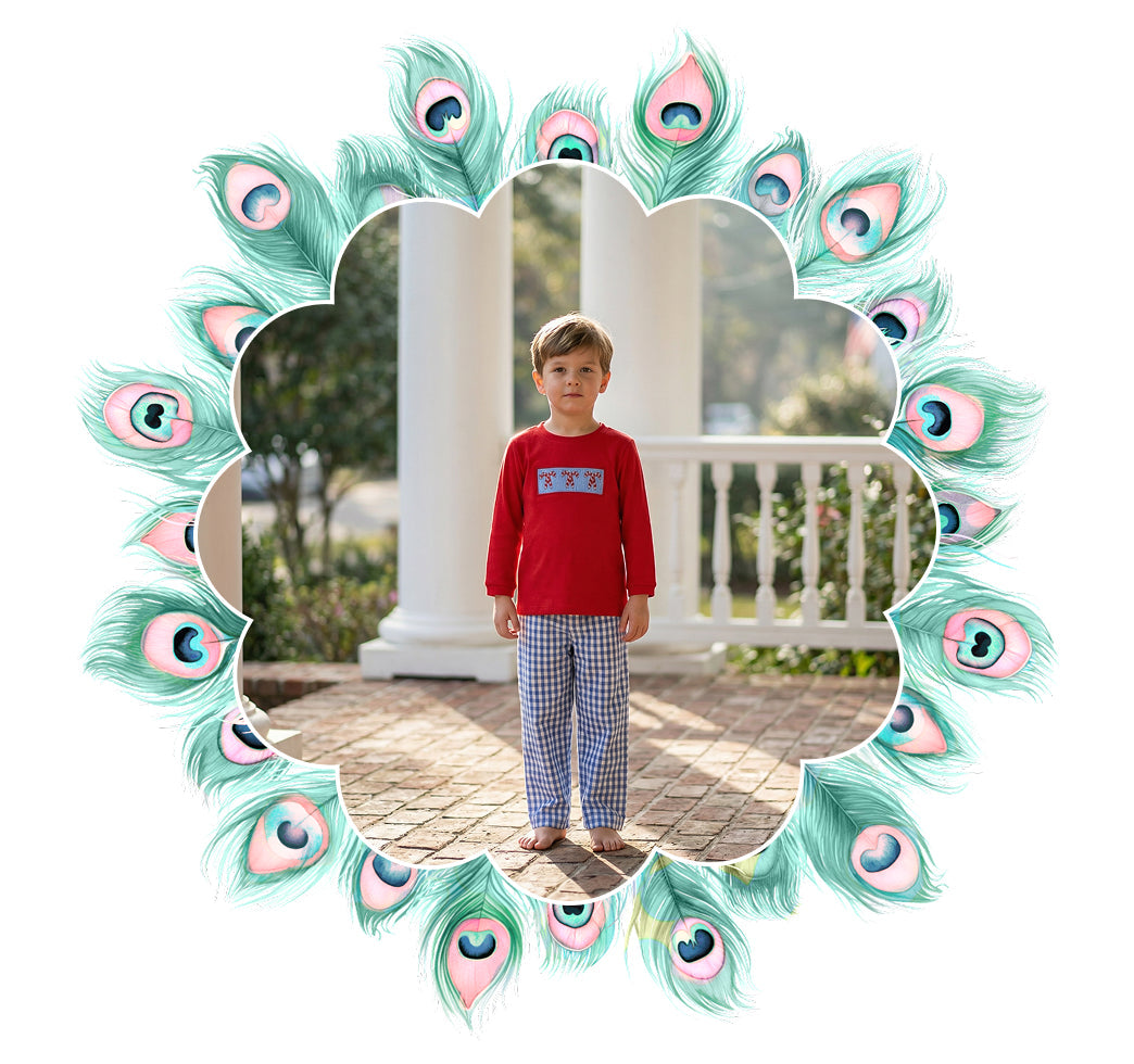 Young boy wearing a red smocked holiday shirt and gingham pants for the boys sets collection.