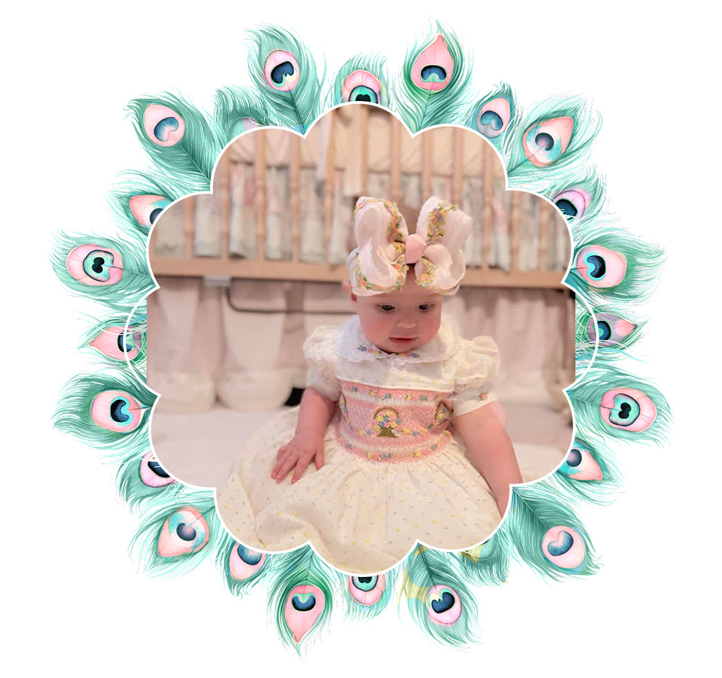Baby girl wearing a vintage hand-smocked dress with hair bow for the Girls-Smocked Collection