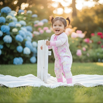 EVERLY’S FLOWERS RUFFLE BUTT FOOTIE SLEEPER