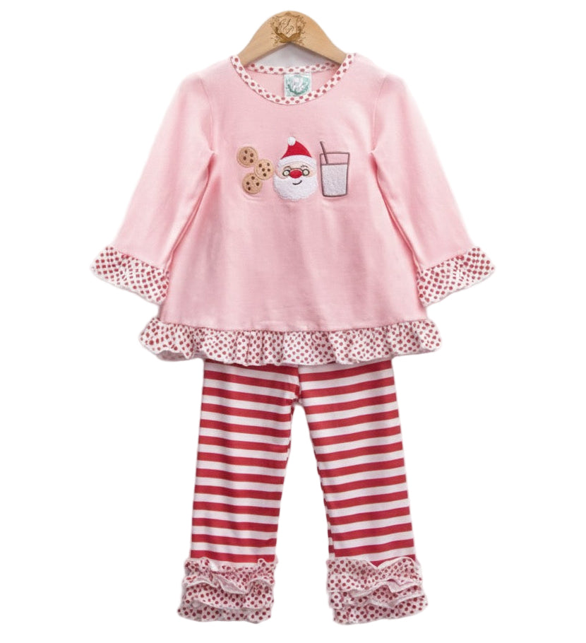 Girls pink Christmas outfit featuring an embroidered Santa, milk, and cookies design on a ruffle tunic, paired with red and white striped pants with polka dot trim.