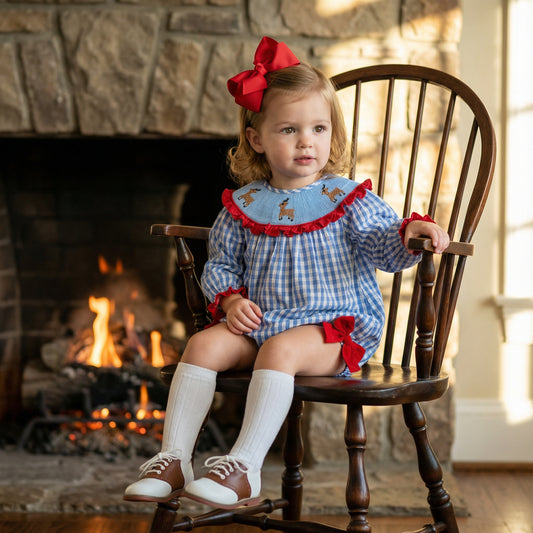 Shop our Girls Smocked Reindeer Gingham Bubble! Perfect for holiday photos. Features hand-smocked details & red ruffle trim.