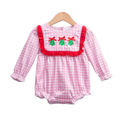 Pink gingham baby girl romper featuring a red ruffle bib with three embroidered Christmas trees and red bows, long sleeves, and bubble hems, hanging on a wooden hanger against a white background.