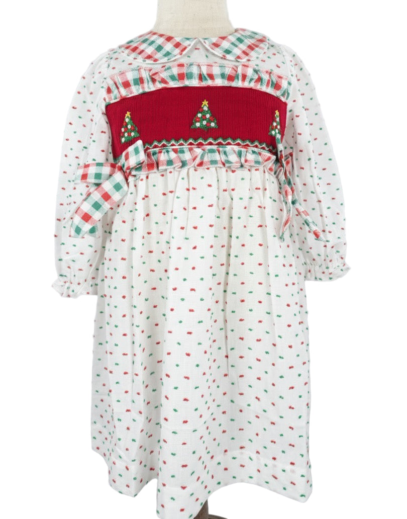 Girls white Swiss Dot dress featuring a red hand smocked bodice with embroidered Christmas trees and plaid accents.