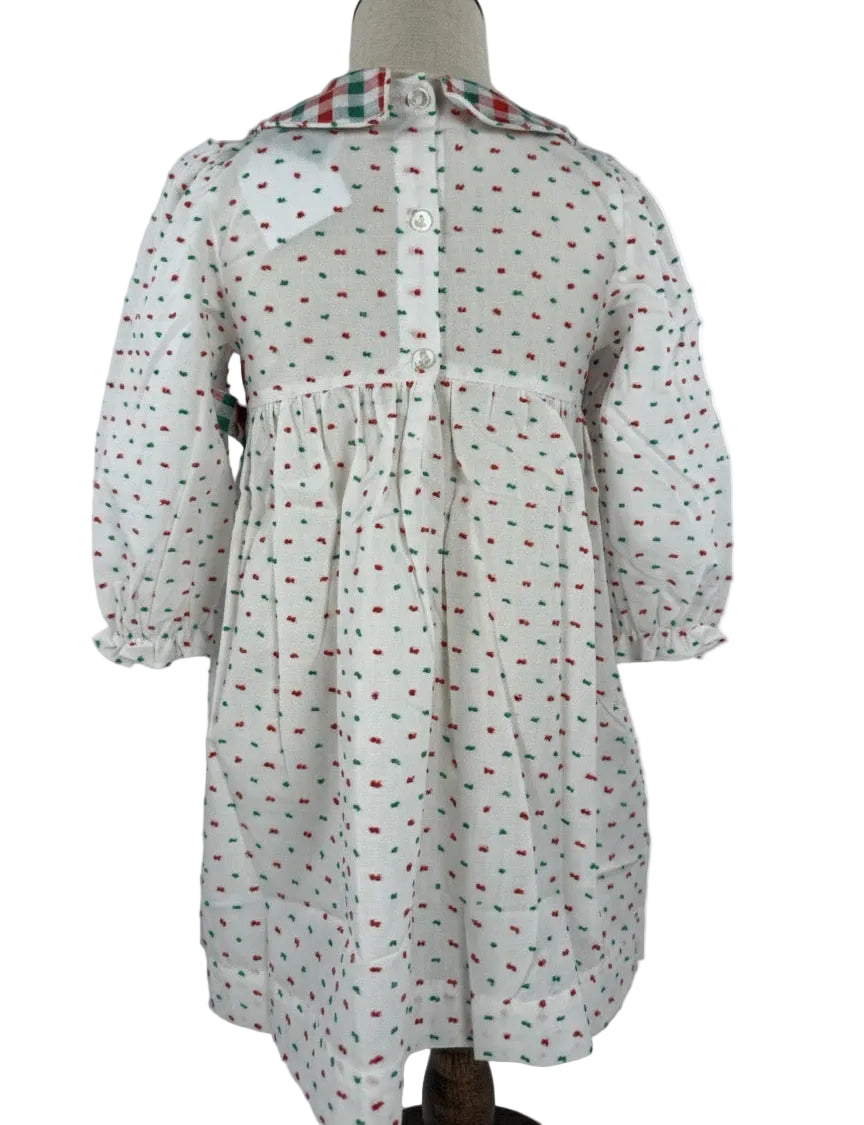 Back image of a white hand smocked dress featuring red and green Swiss Dot fabric, perfect for Christmas.