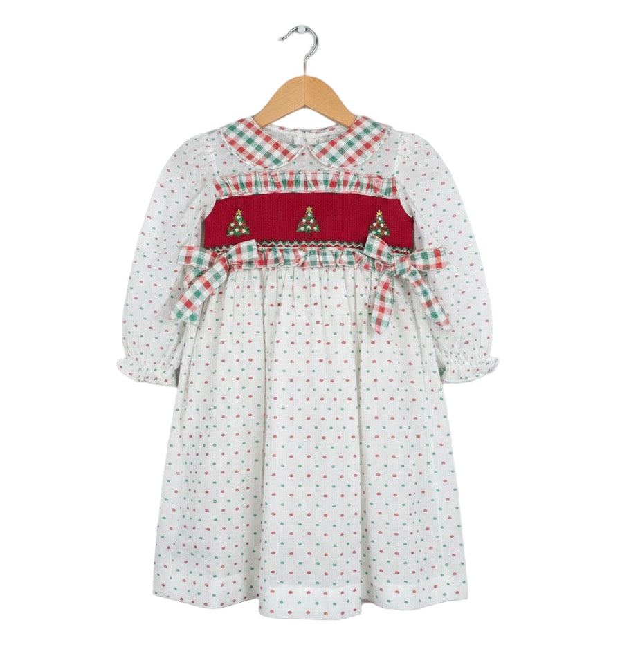 Girls white Swiss Dot dress featuring a red hand smocked bodice with embroidered Christmas trees and plaid accents.