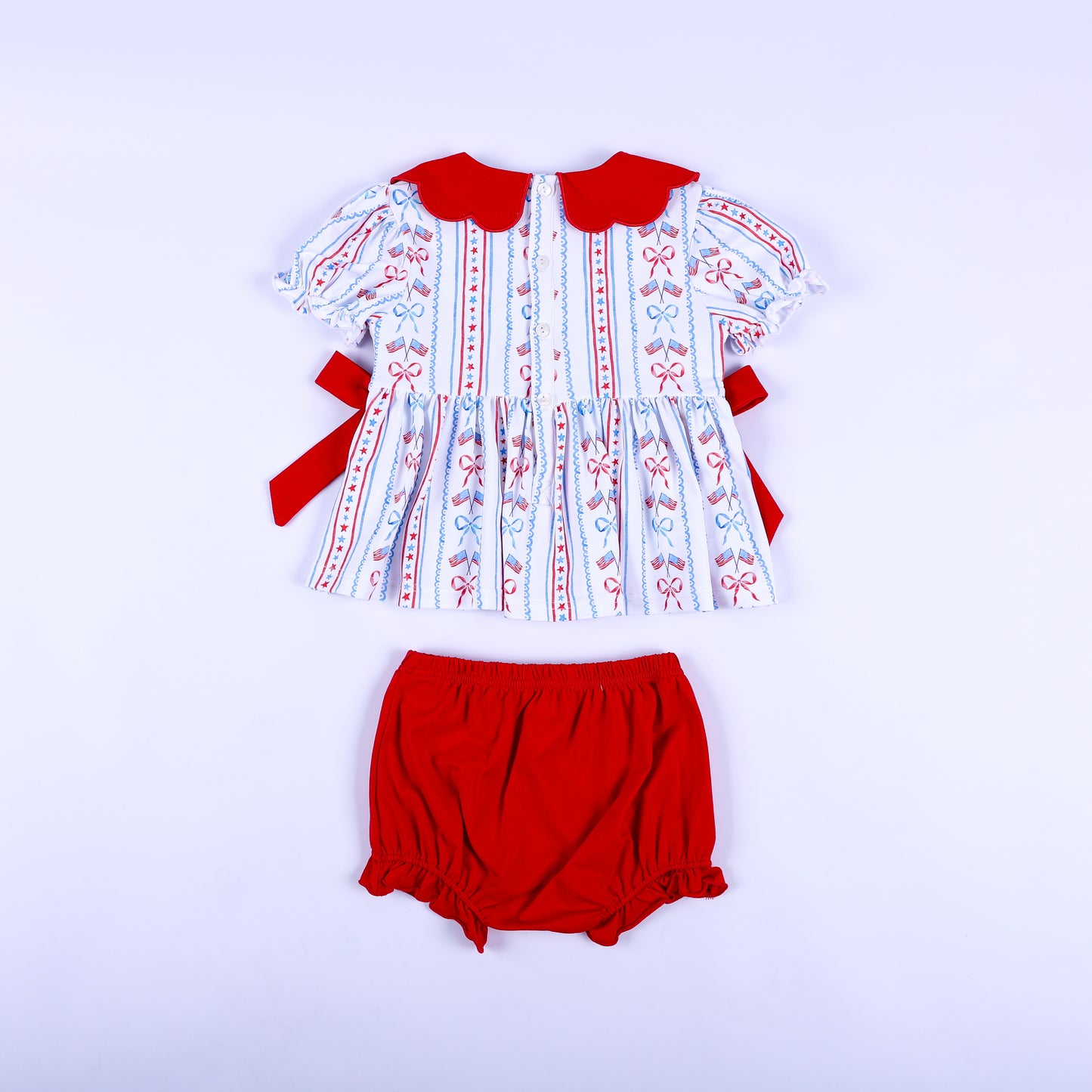Back view of America the Beautiful smocked diaper set showing button closure top and red elastic bloomer bottoms.