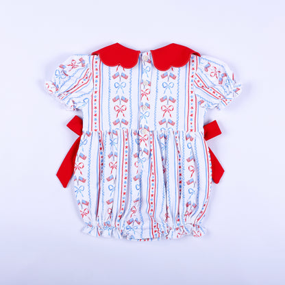 Full back view of America the Beautiful hand smocked baby bubble featuring button-down back closure and red side bows.
