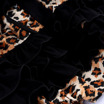 Close up of tiered black ruffles on animal kingdom leopard print hand smocked safari mouse baby girl bubble romper.