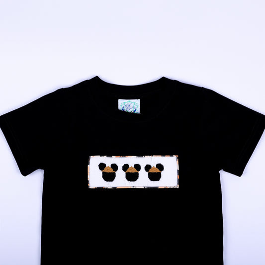 Close-up of boys black crewneck t-shirt featuring hand smocked safari mouse embroidery plate on chest.