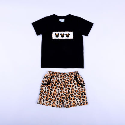 Front view of boys black shirt with smocked safari mouse plate and matching leopard print shorts set.