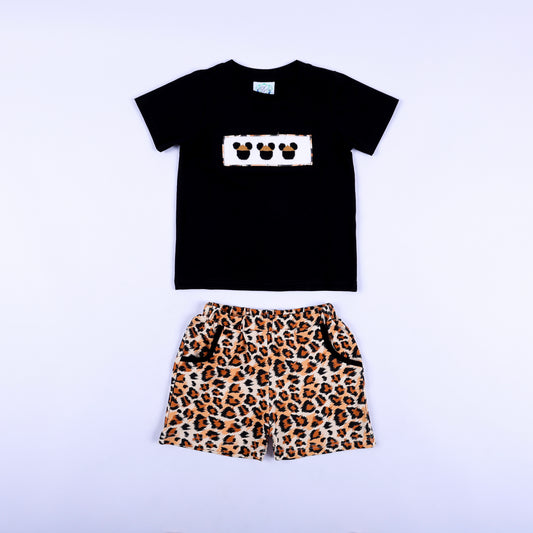 Front view of boys black shirt with smocked safari mouse plate and matching leopard print shorts set.