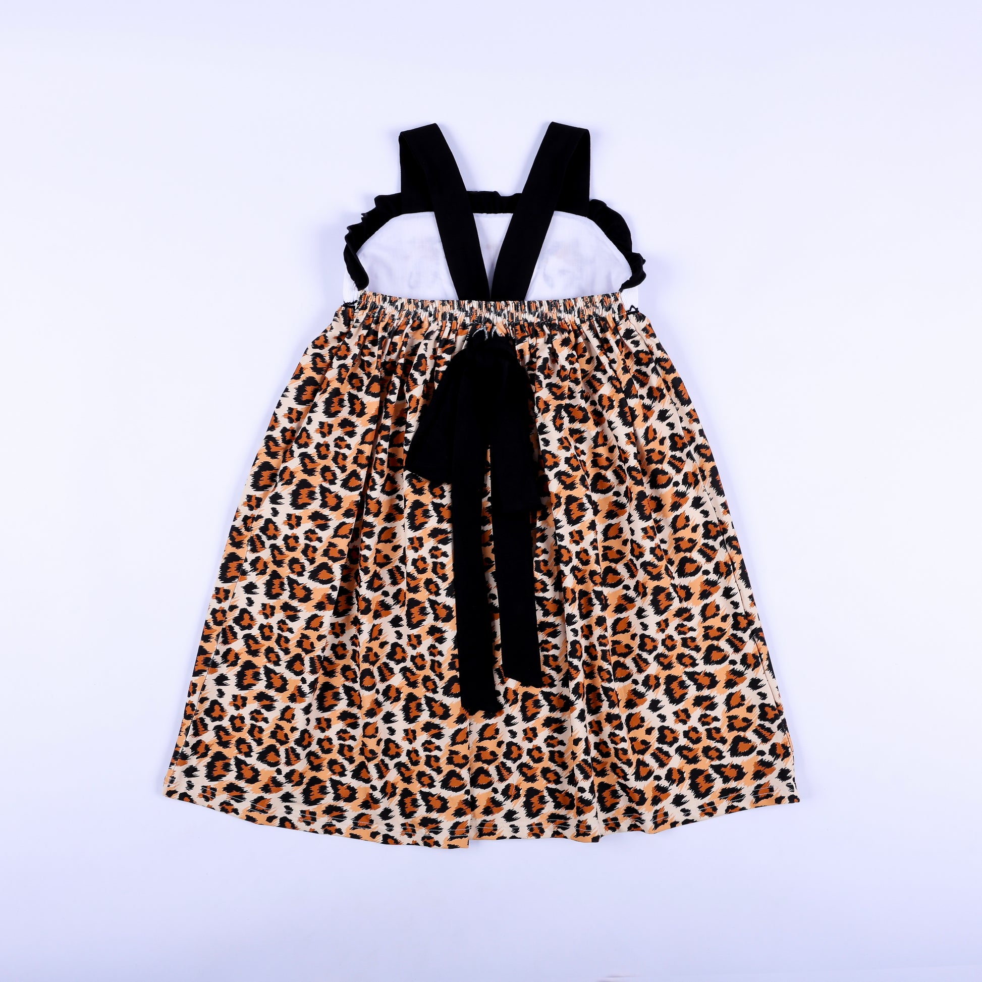 Full back view of a girls animal print safari mouse hand smocked dress showing criss cross straps and bow.