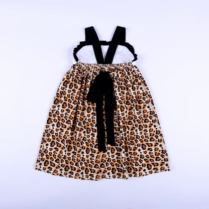 Full back view of a girls animal print safari mouse hand smocked dress showing criss cross straps and bow.