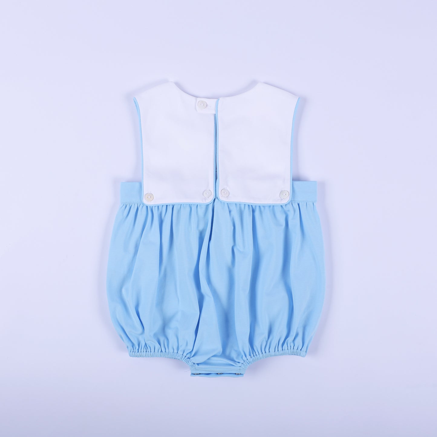 Full back view of light blue classic baby boy bubble romper featuring white top panel with button closures.