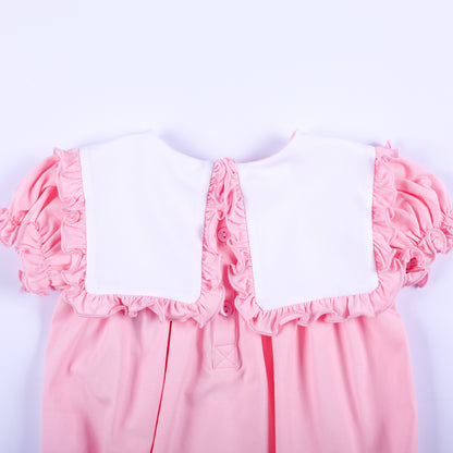 Back collar close-up showing pink buttons and white ruffled square bib on a baby girl boutique bubble romper.