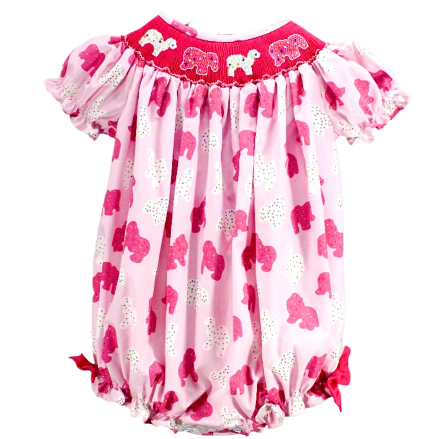 Baby girl pink bubble romper featuring an all-over sprinkle elephant print, puff sleeves, and a fuchsia smocked yoke with embroidered elephants.