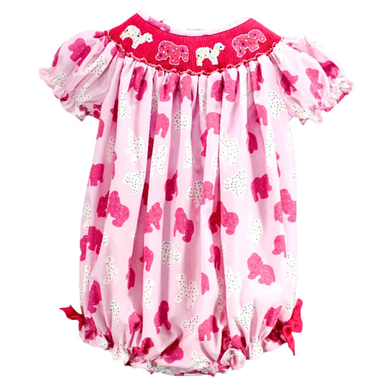 Baby girl pink bubble romper featuring an all-over sprinkle elephant print, puff sleeves, and a fuchsia smocked yoke with embroidered elephants.