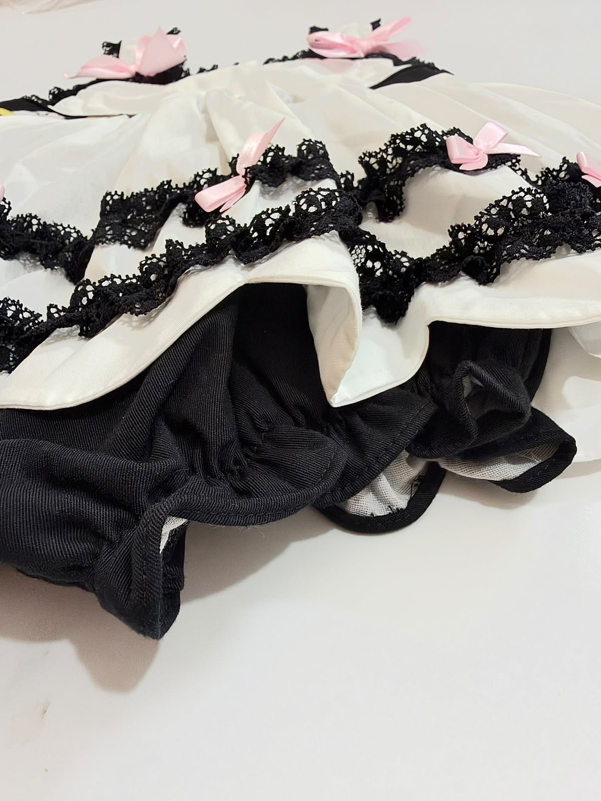 Attached black bloomer bubble bottom beneath tiered scalloped skirt on girls Halloween romper