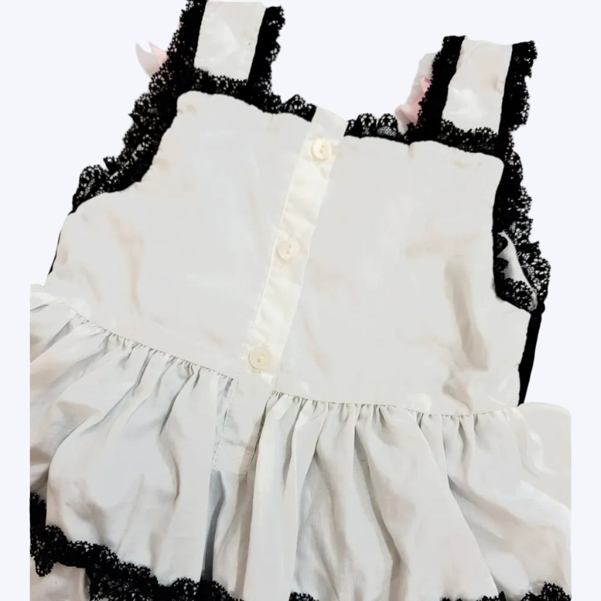 Back button closure and black lace straps on baby girls hand-smocked Halloween bubble romper