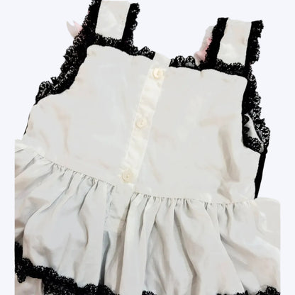 Back button closure and black lace straps on baby girls hand-smocked Halloween bubble romper