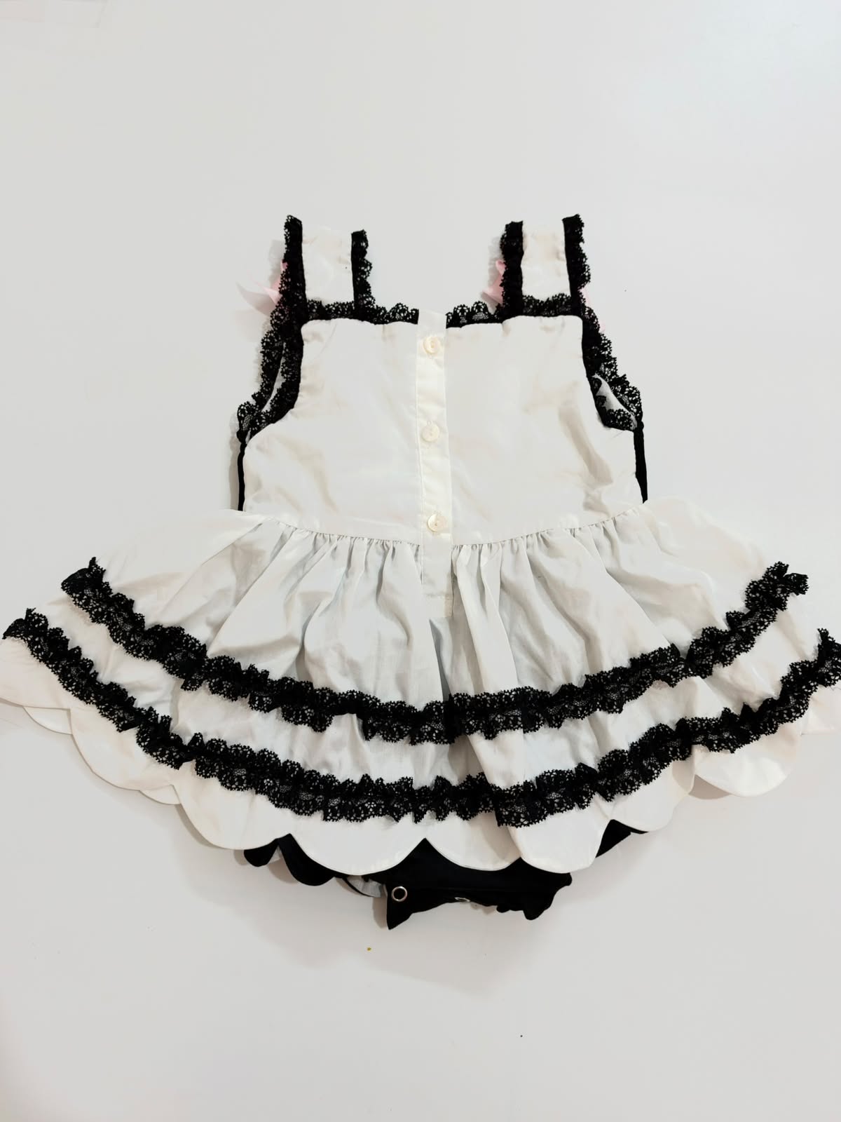 Full back view of baby girls Halloween bubble romper showing button placket and tiered skirt