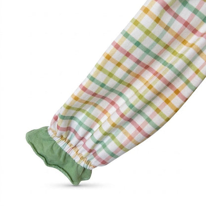 Long sleeve detail of pastel plaid baby romper with sage green ruffle trim at the elastic cuff