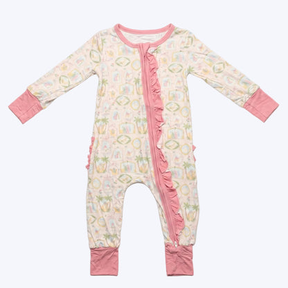 Baby zippered romper with pink ruffled trim and tropical print flat lay on a solid light grey studio backdrop.