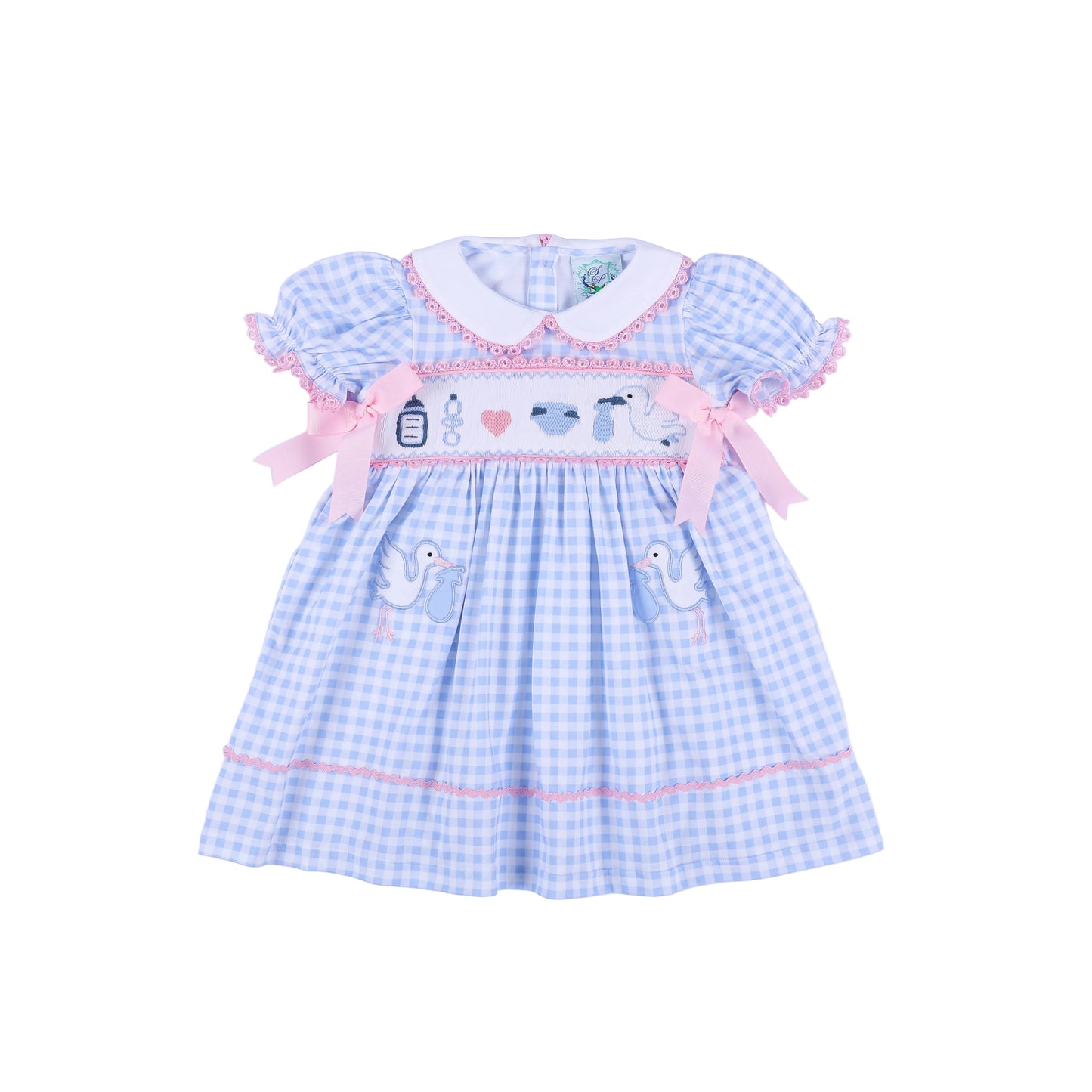 Front view of light blue gingham gender reveal smocked dress with pink bows and hand embroidered baby stork details.