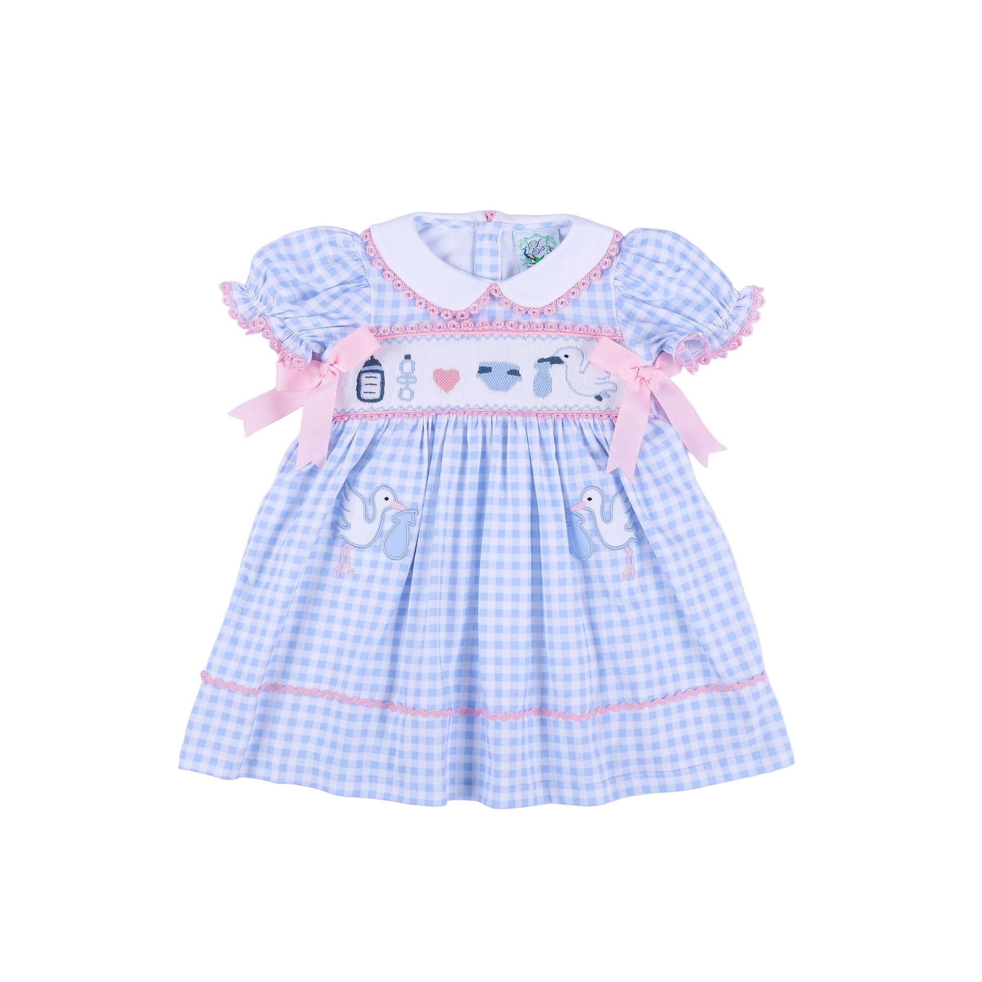 Front view of light blue gingham gender reveal smocked dress with pink bows and hand embroidered baby stork details.