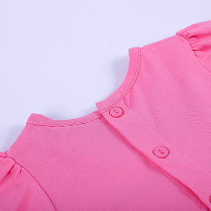 Close-up detail of back button closure and soft pink neckline on hand-smocked fashionista baby girl bubble outfit.