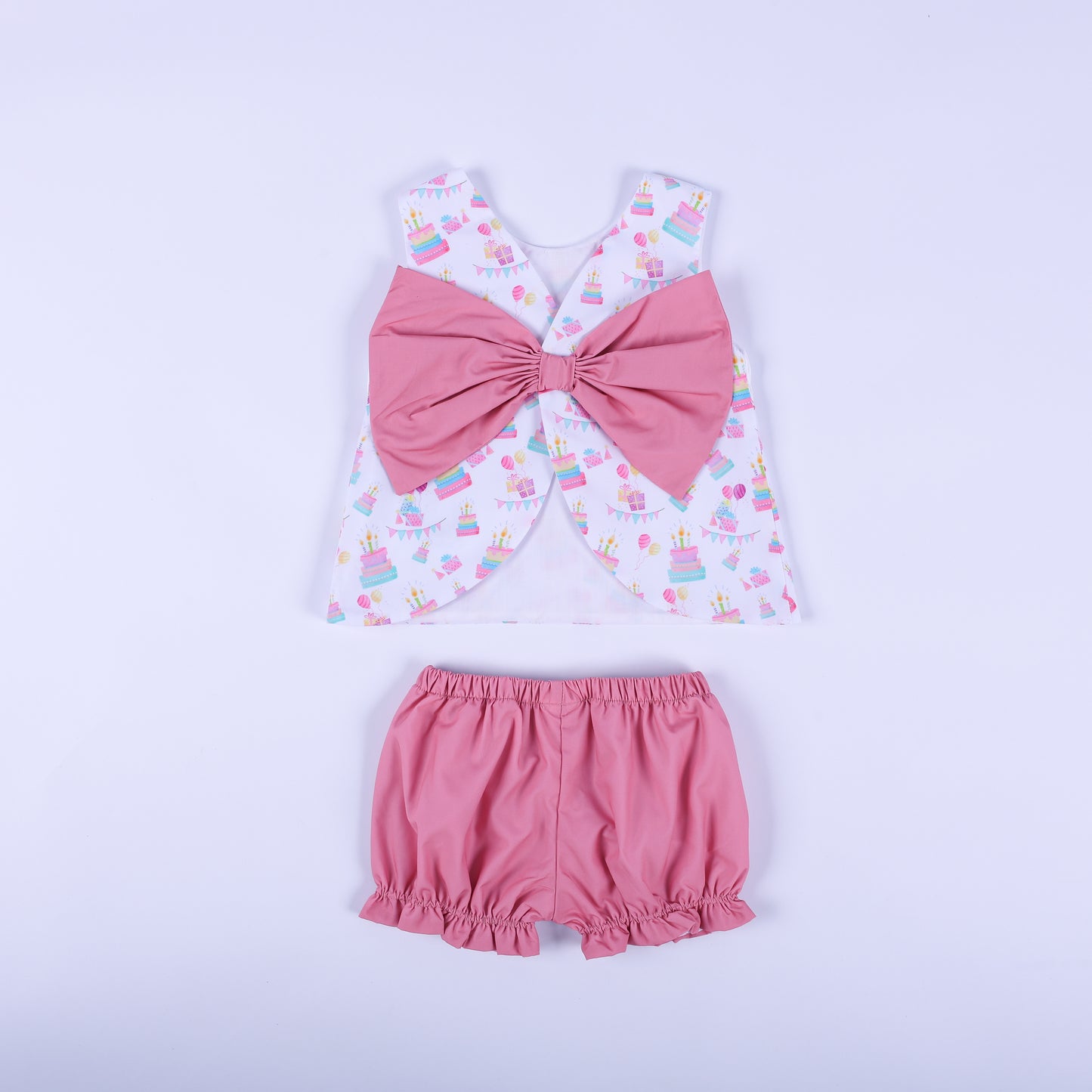 Back view of the birthday girl bloomer set showcasing the oversized solid pink statement bow and ruffle bloomers.