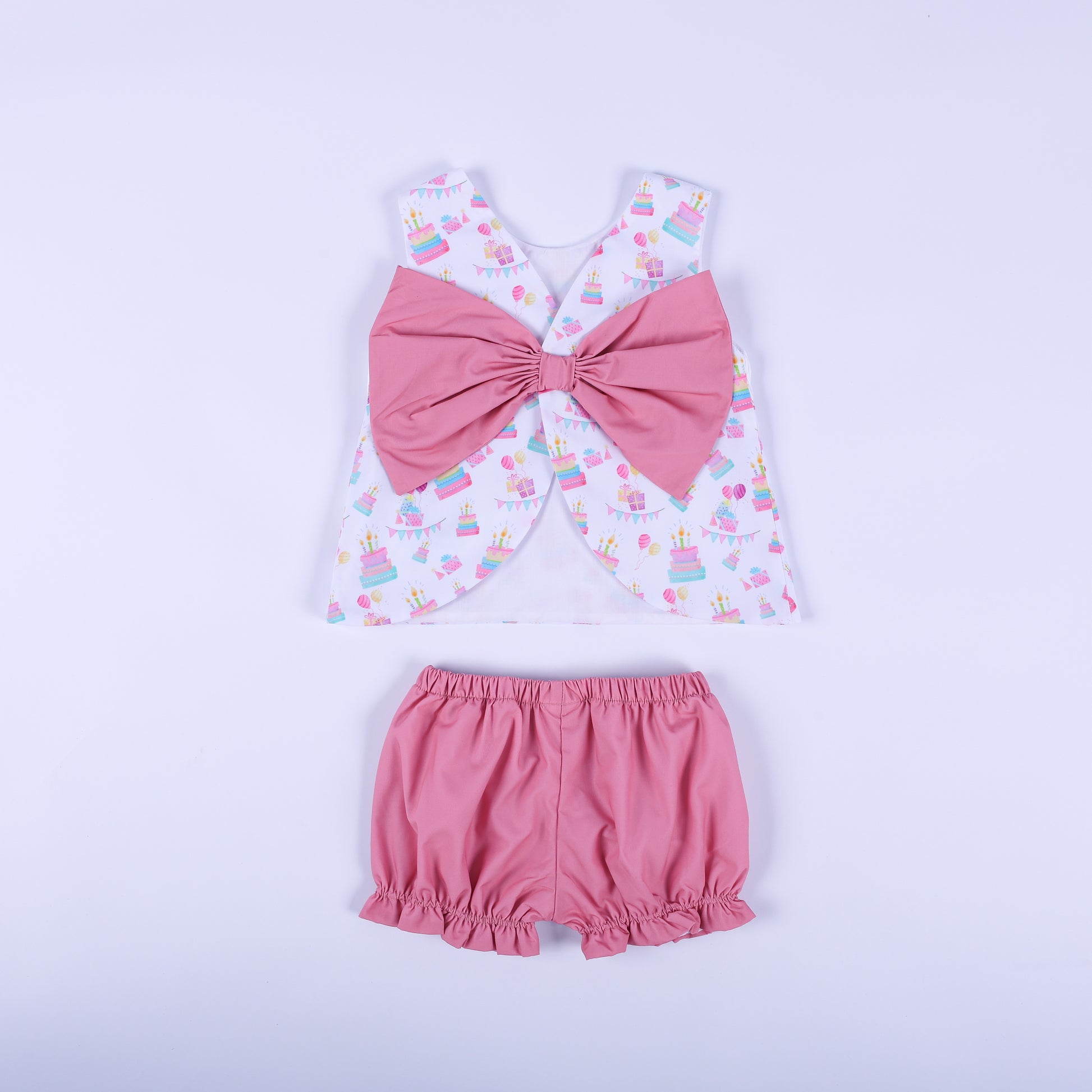 Back view of the birthday girl bloomer set showcasing the oversized solid pink statement bow and ruffle bloomers.
