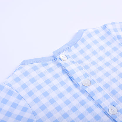 Close up detail of upper back button closures on light blue gingham hand smocked baby boy sleep sack gown.