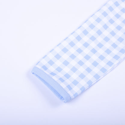 Detailed view of soft long sleeve cuff and light blue trim on baby gingham hand smocked sleep sack layette.
