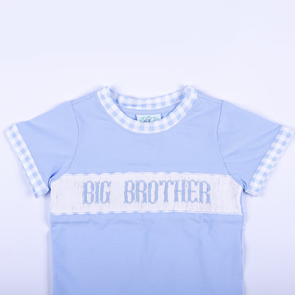 Close-up of light blue shirt featuring hand smocked Big Brother embroidered text panel and gingham collar trim.