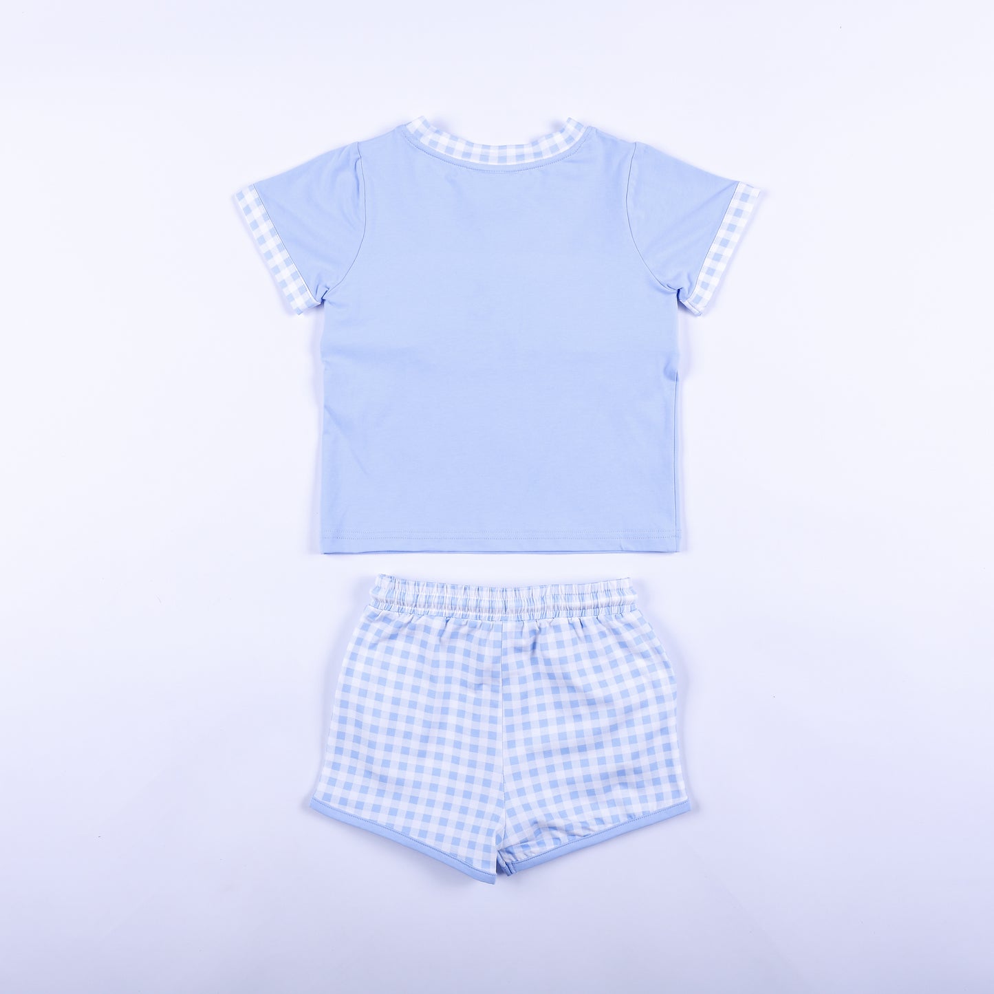 Back view of boys light blue Big Brother set with solid blue shirt back and matching gingham shorts outfit.