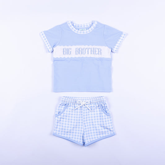 Front view of blue gingham big brother hand smocked shorts set with embroidered chest panel and matching shorts.