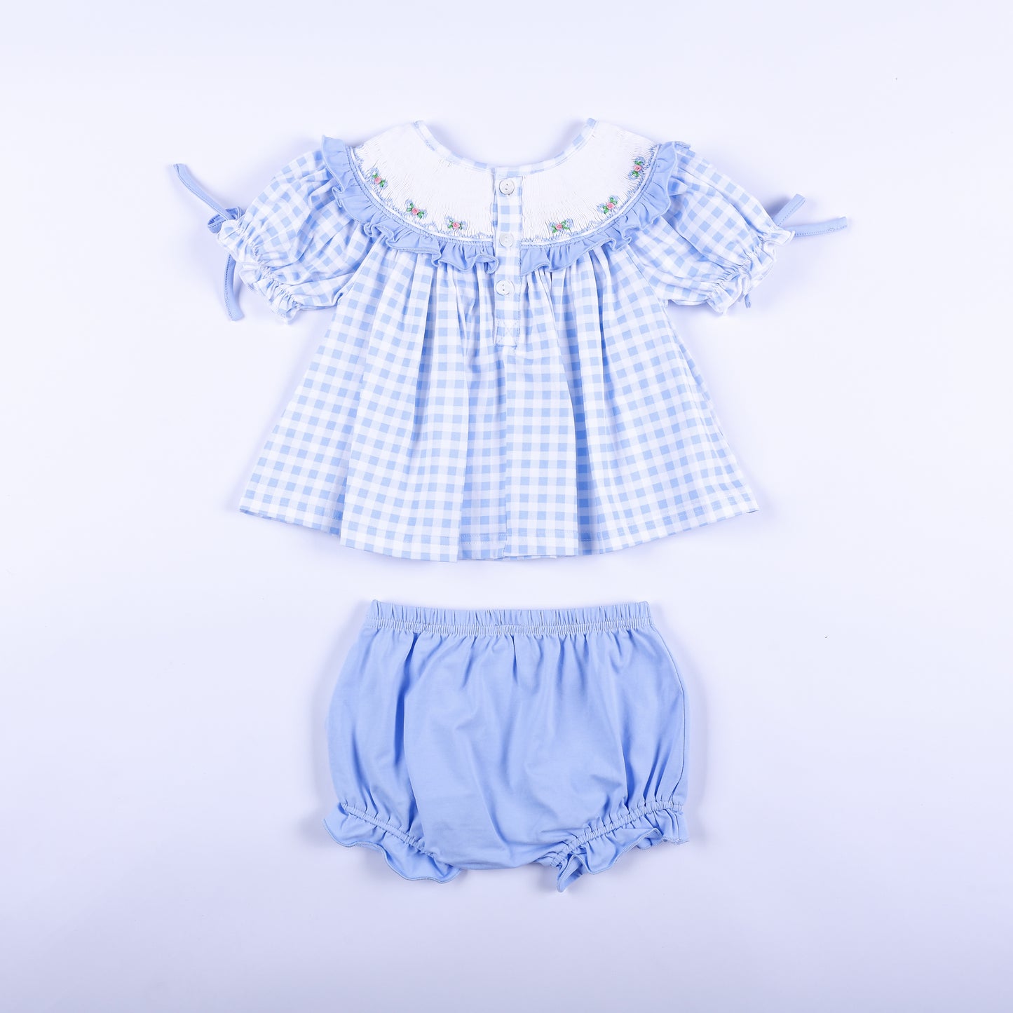Back full set view of blue gingham hand-smocked Big Sister top with buttons and light blue bloomer set.