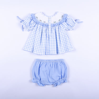 Back full set view of blue gingham hand-smocked Big Sister top with buttons and light blue bloomer set.