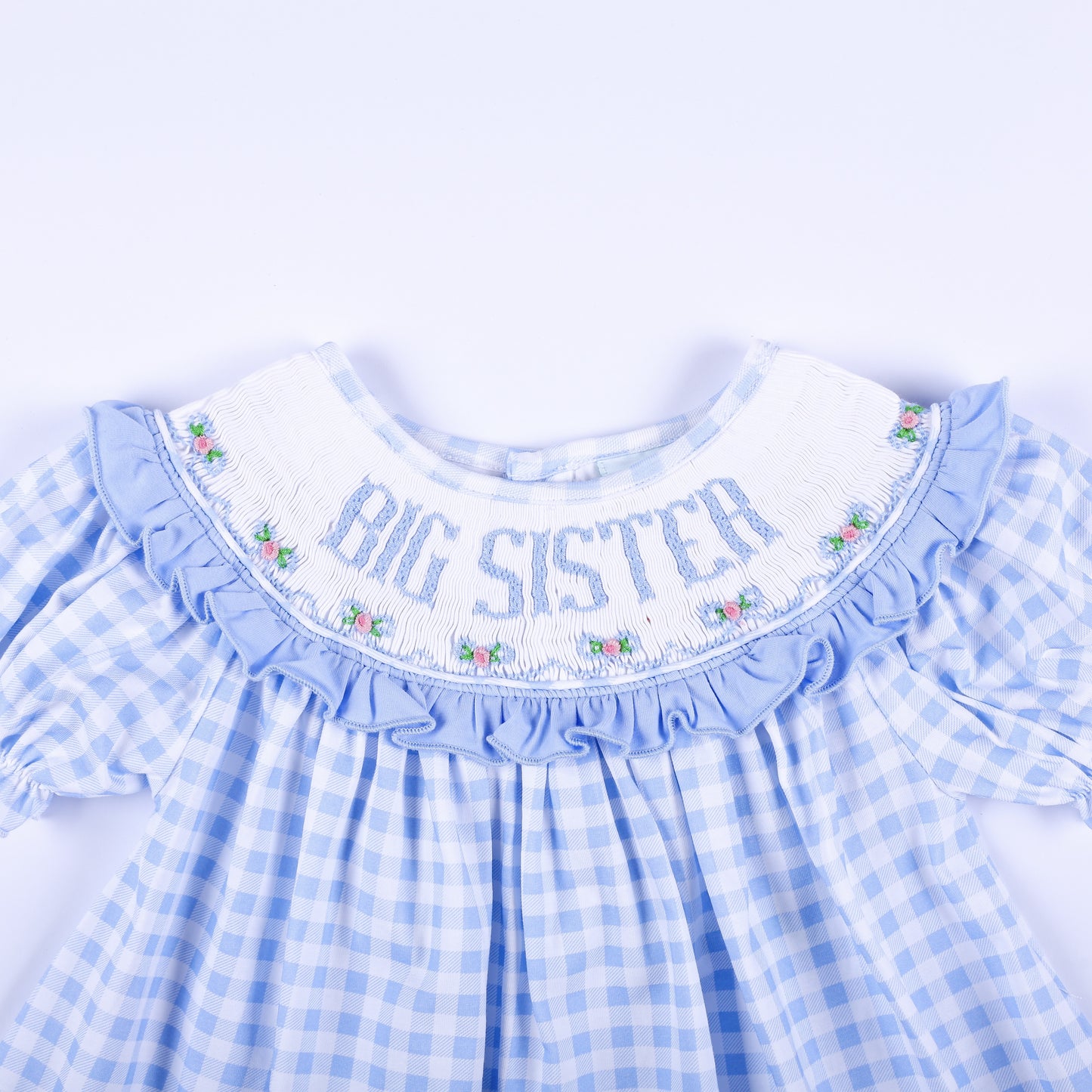 Detailed front smocked collar reading Big Sister with delicate floral hand embroidery on blue gingham.